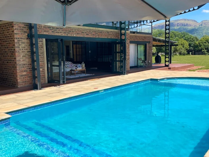 Luxury hotel pool with a stunning sunset view over the water