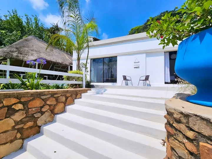 Luxurious tropical villa exterior with lush greenery